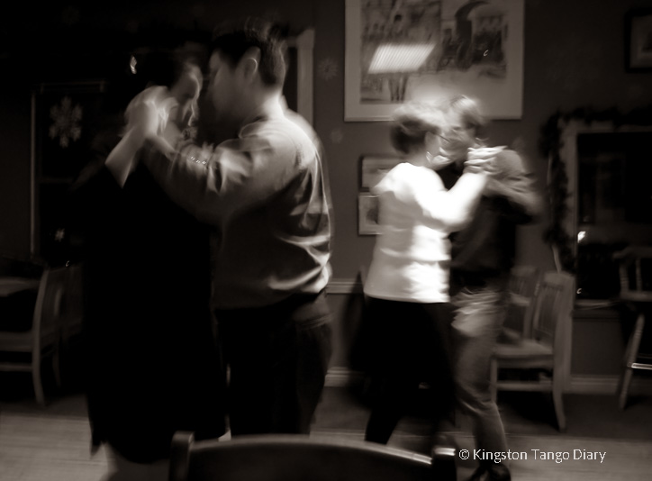 People are dancing tango in a pub.